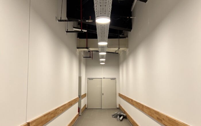 Neuer Flur mit weißen Wänden und Holzanprallschutz im Allee-Center